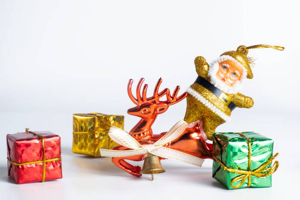 istock Festive Christmas decorations with Santa, reindeer and colorful gift boxes on white background 2193884202