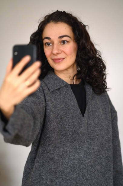 istock An isolated woman's portrait with a cell phone 2193885646