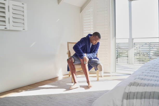 istock Man with leg prosthesis sitting on chair 2193886394