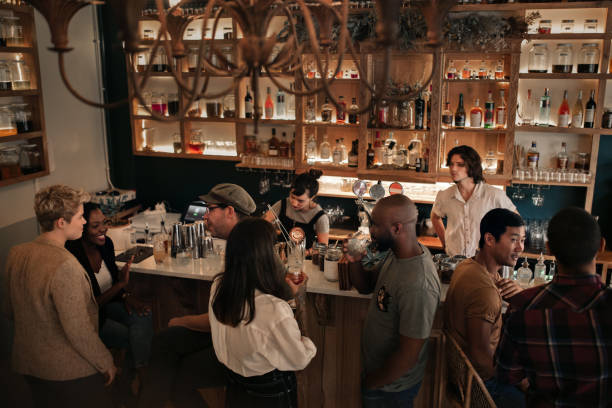istock Diverse young people enjoying a night out at the pub 2193888857
