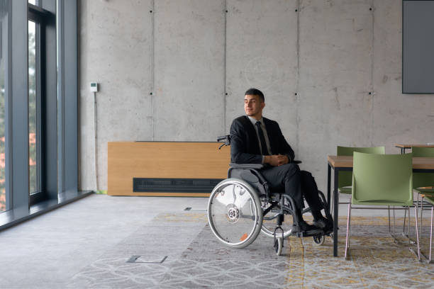 istock A director in a wheelchair sitting alone in an empty office, deeply reflecting on business strategies and decisions, contemplating the path forward with focused determination. 2193889082