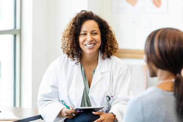 istock Smiling Female Doctor Using Tablet in Medical Office 2193889791