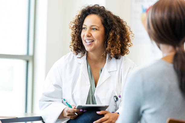 istock Confident Female Doctor Using Tablet, Discussing Healthcare 2193889796