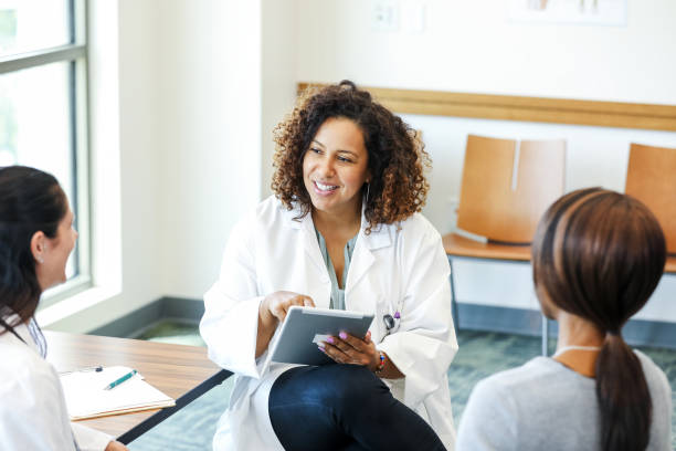 istock Doctor using tablet, discussing healthcare with patients 2193889805