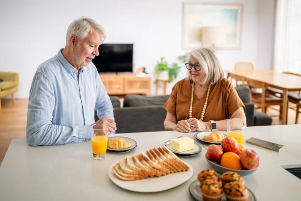 istock Couple enjoys breakfast with pastries and orange juice. 2193890265