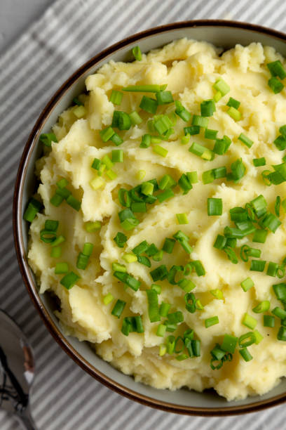 istock Homemade Mashed Potatoes with Chives in a Bowl, top view. Flat lay, overhead, from above. 2193890627