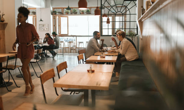 istock Friends talking together over drinks and lunch in a bistro 2193891332