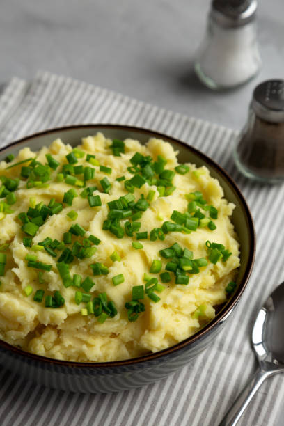 istock Homemade Mashed Potatoes with Chives in a Bowl, side view. 2193891443