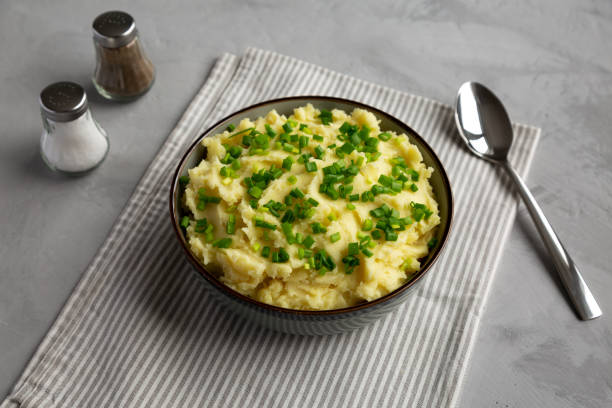 istock Homemade Mashed Potatoes with Chives in a Bowl, side view. 2193891472