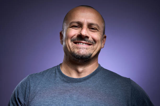 istock Happy mature man on purple background 2193892198