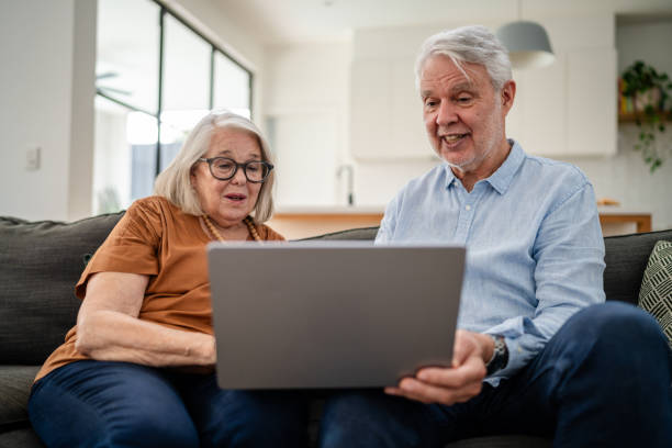 istock Senior couple using laptop together, discovering online 2193893898
