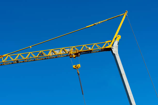 istock Construction crane stands against a clear blue sky 2193894039