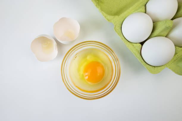 istock Raw egg bowl and eggs in a tray on a white background. 2193895985