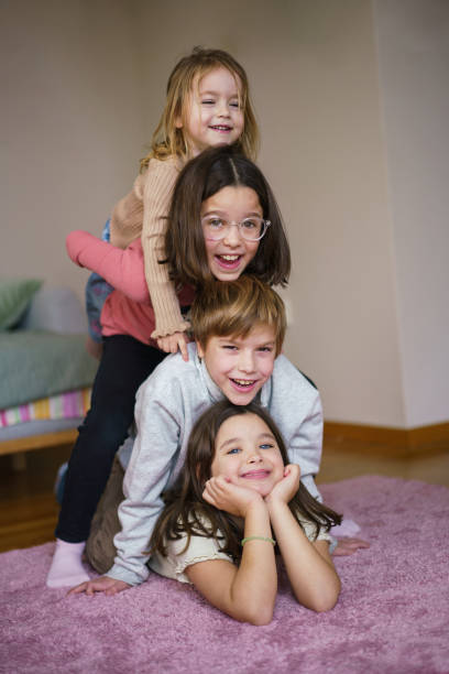 istock Children lying on a carpet and looking at camera 2193896423