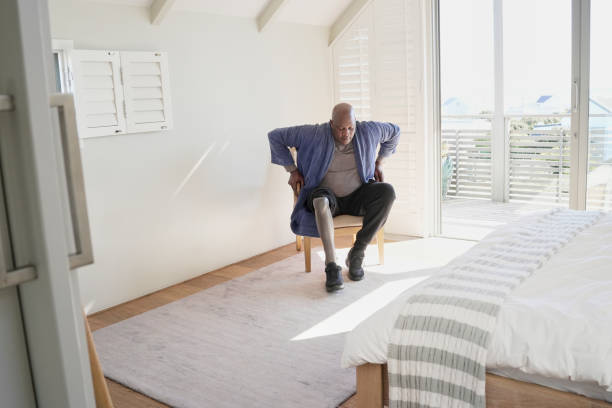 istock Man with leg prosthesis sitting on chair 2193897191