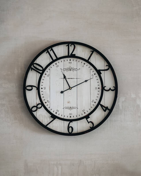 istock Vintage wall clock on textured concrete background 2193898264