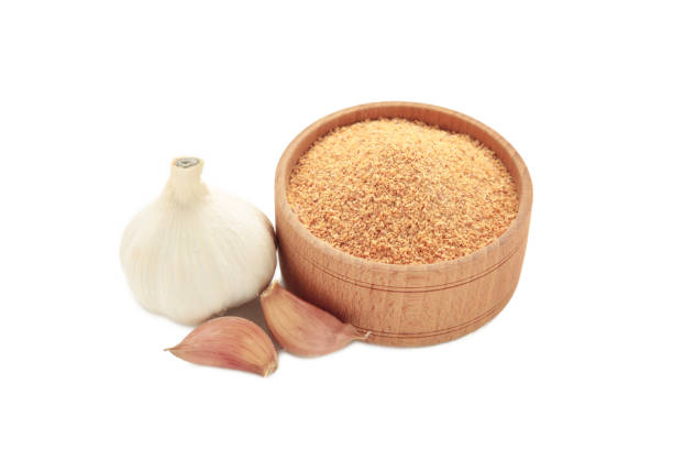 istock Fresh garlic and garlic powder in bowl isolated on white background. Using spices for meals. Top view 2193900105