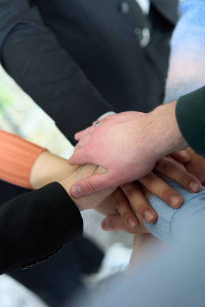 istock A top view of business people joining hands in a circle, symbolizing unity, collaboration, and shared success in the workplace 2193900845