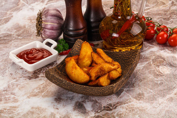 Fried rustic golden Idaho potato with tomato sauce