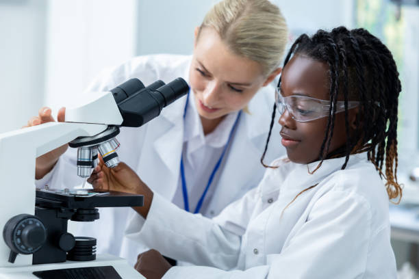 istock Teacher and a student working in a school scientific laboratory 2193902117