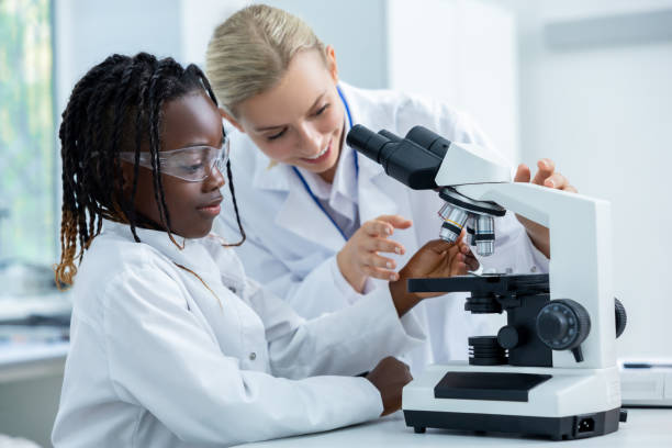 istock Teacher and a student working in a school scientific laboratory 2193902121
