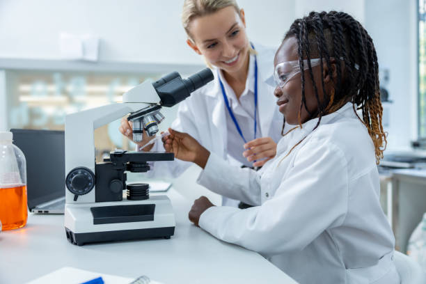 istock Teacher and a student working in a school scientific laboratory 2193902125