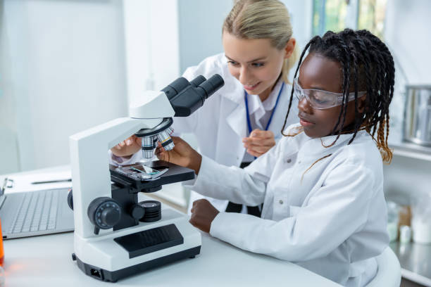 istock Teacher and a student working in a school scientific laboratory 2193902127