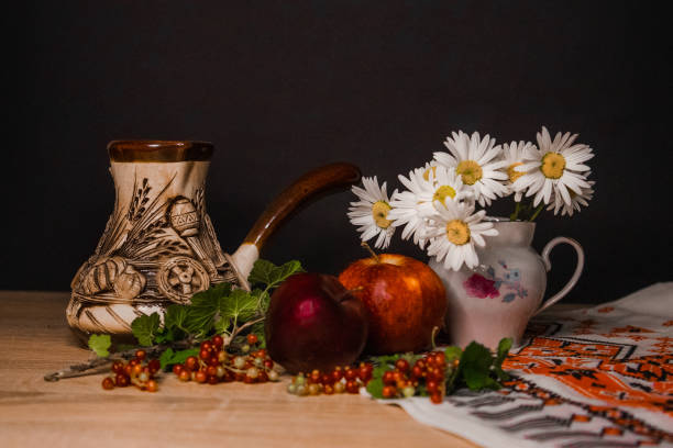 a pitcher of chamomile and an apple. High quality photo