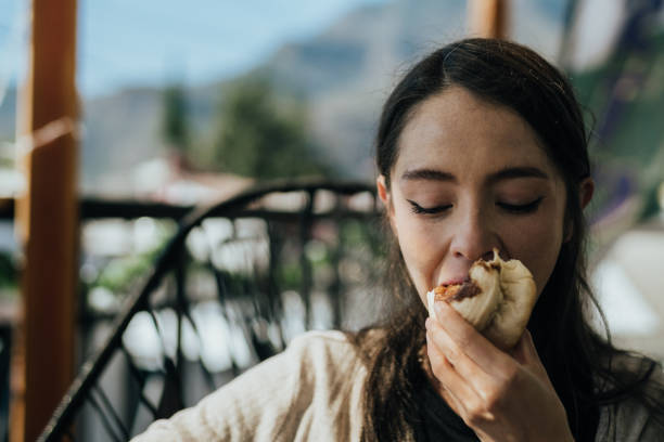 istock Girl having a delicious cinnamon roll for breakfast. 2193903788