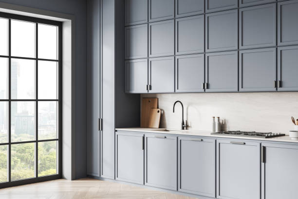 istock Modern kitchen interior with light blue cabinets, large window with city view, and minimalist design. 3D Rendering 2193903879