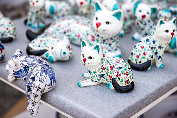 White ceramic cats with oriental patterns are on a counter of souvenir shop in Marmaris, Turkey