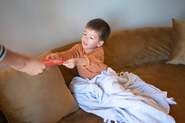 istock Child Receiving Red Envelope During Chinese Lunar New Year 2193905533
