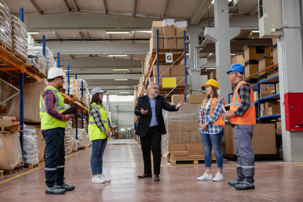 istock Collaborative Innovation: Brainstorming and Discussion in Factory Warehouse Corridor. 2193906391
