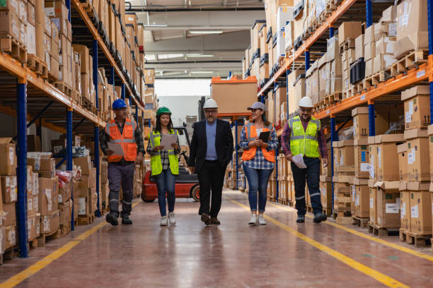 istock Collaborative Innovation: Brainstorming and Discussion in Factory Warehouse Corridor 2193906719
