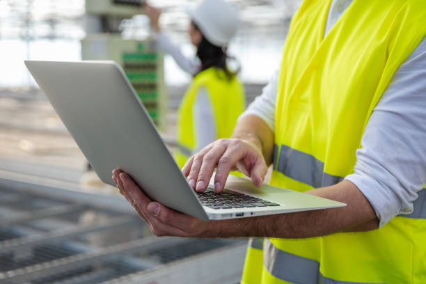 istock Young male engineer with a laptop checking the parameters at the construction site 2193907663