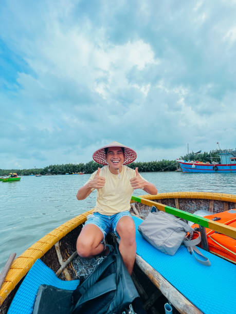 istock Man in Straw Hat Enjoying Boat Ride on Scenic River 2193909112