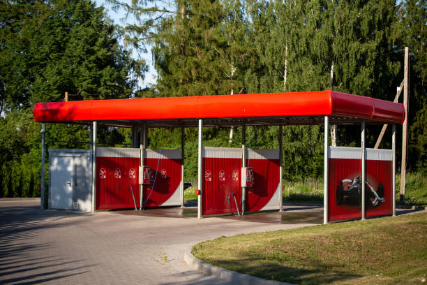 Modern Car Wash Station with Red Roof and Tree Backdrop