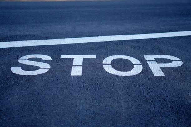 istock stop word painted on the road asphalt 2193911510