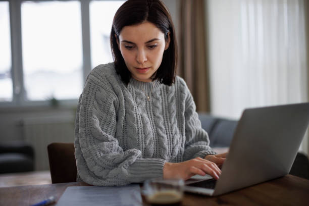 istock Focused woman typing her resume for a job application 2193912968