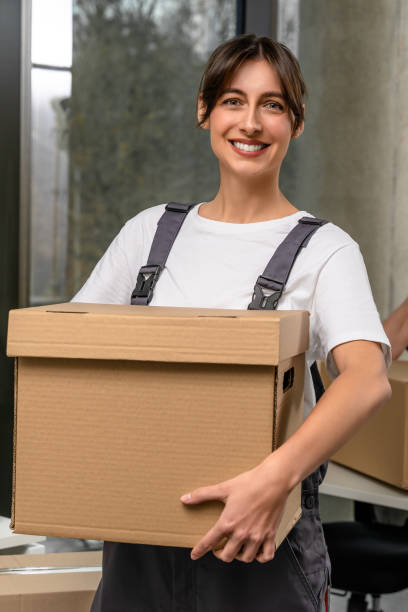 istock Smiling dark-haired girl holding a parcel before sending 2193913522