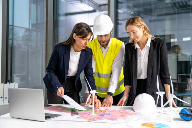 istock Group of engineers discussing new wind power project and looking involved 2193913565