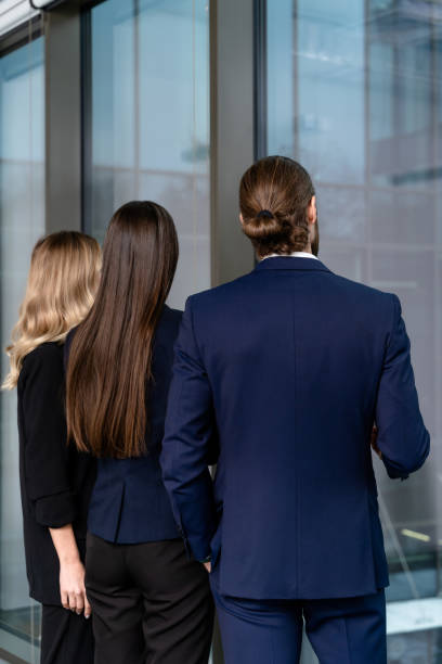 istock Group of colleagues in the office talking and looking interested 2193913569
