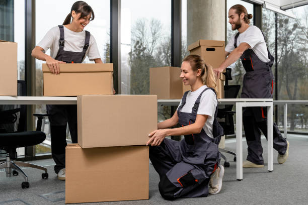 istock Group of young people packing the boxes and looking involved 2193913671