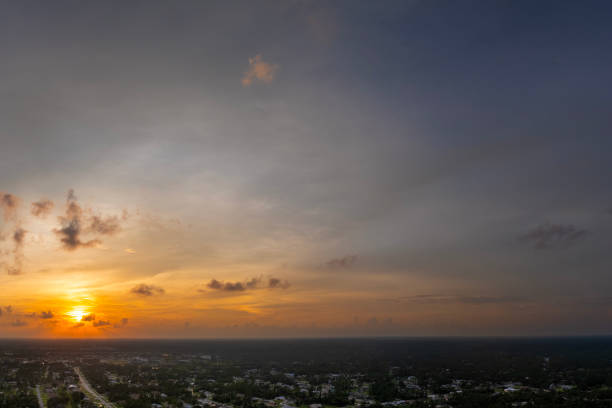 istock Evening sunset sky with colorful clouds over dark land. Panoramic skyscape 2193914710