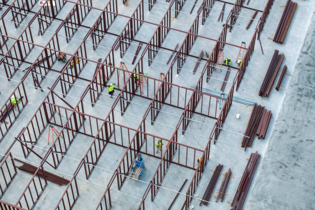 istock Construction site with hardhat workers assembling metal frame walls. Aerial view of large development area of commercial structure. Real estate market in the USA 2193914752