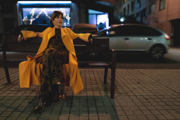 istock Woman sitting on a bench 2193915151