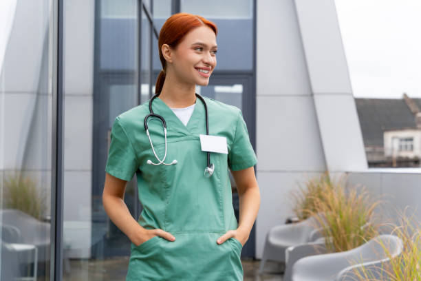 istock Woman doc with stethoscope wearing uniform friendly smiling while posing in hospital corridor 2193916032