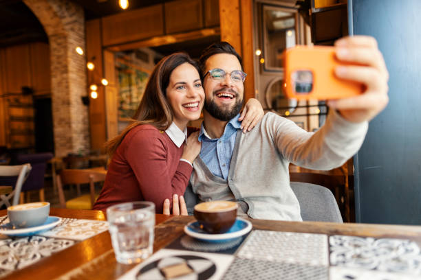istock Young affectionate couple sitting in cafe and taking selfies for Valentines day. 2193918025