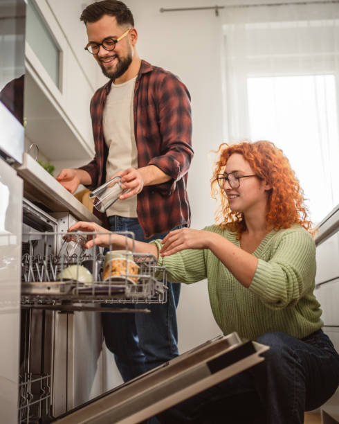 istock boyfriend help girlfriend to put dishes in dishwasher in kitchen 2193924886