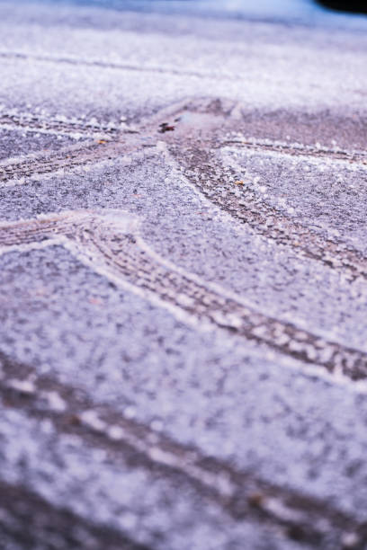 Tire tracks on an icy parking lot.